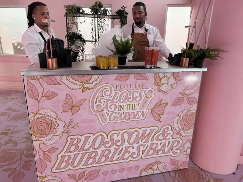 P.Louise Gloss in the Garden Blossom and Bubbles branded bar with floral artwork and Mr Flavour bartenders preparing cocktails