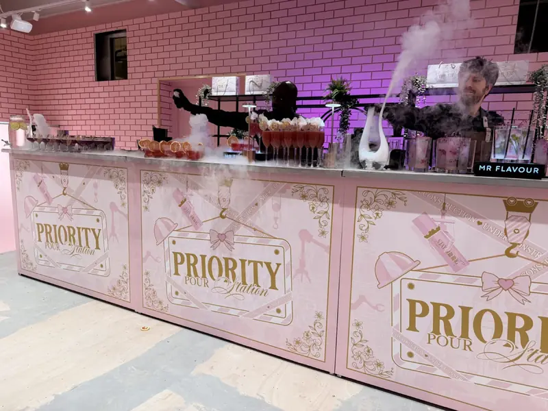 P.Louise Priority Pour Station branded pink and gold bar with dry ice mist rising from cocktails, delivered by Mr Flavour