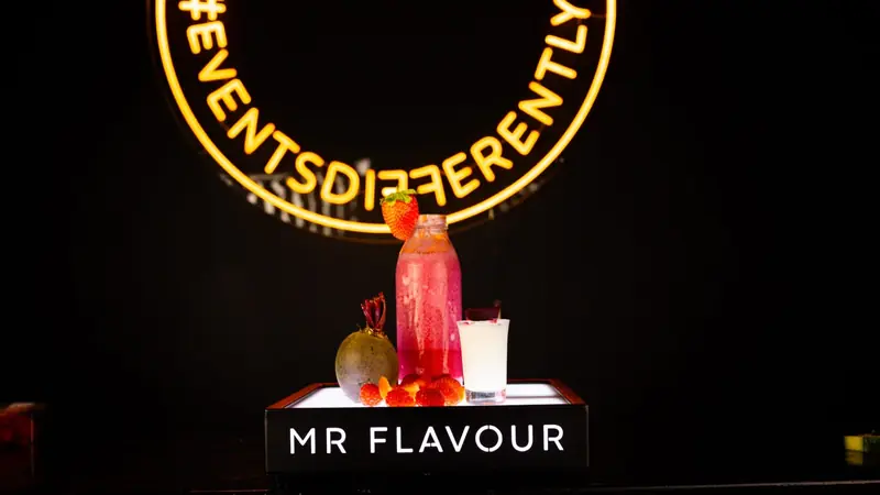 Branded Mr Flavour smoothies and juices on a lit bar plinth at a Softcat office event