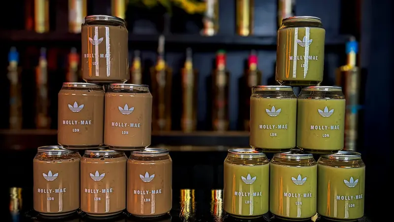 Two branded Adidas x Molly-Mae cans of iced latte and iced matcha