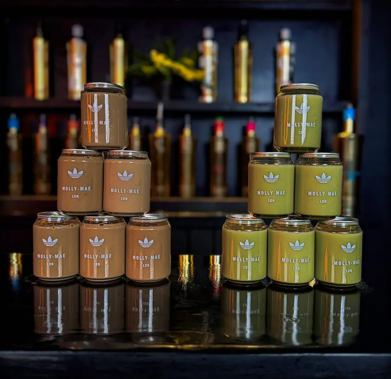 Custom branded canned drinks lined up on a bar