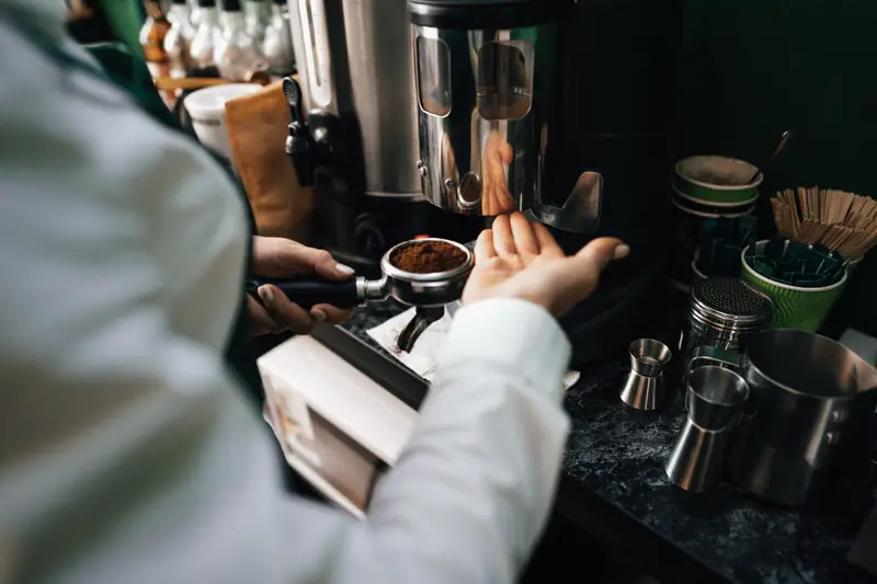 Barista preparing coffee at a branded office coffee bar