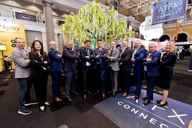 The Mr Flavour and ATFX Connect team at their branded exhibition stand at the Finance Magnates London Summit