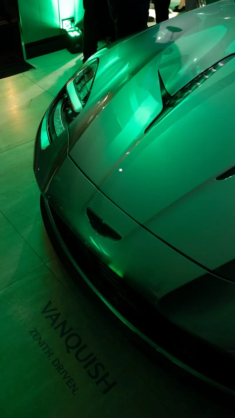 The new Aston Martin Vanquish lit in green at the Mayfair launch, the Vanquish name on the bodywork