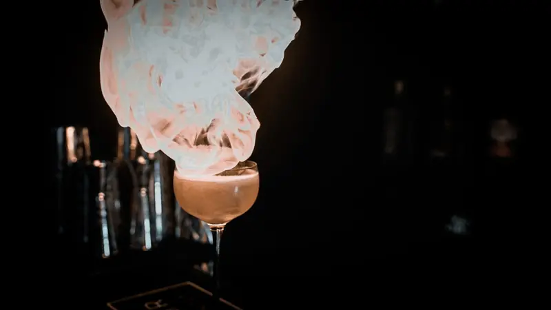 Creme brulee cocktail finished with candyfloss above the glass