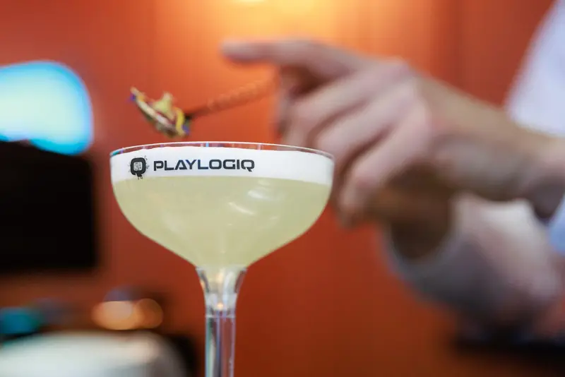 Cocktail served in a coupe with a client logo printed onto the foam
