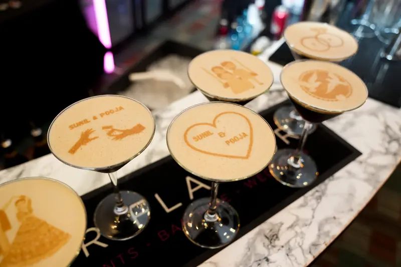 Five personalised espresso martinis with Ripples printed designs showing wedding rings, couple names and illustrations