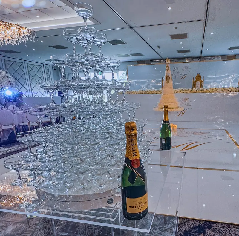 Mr Flavour champagne pyramid display with gold coupe glasses at event