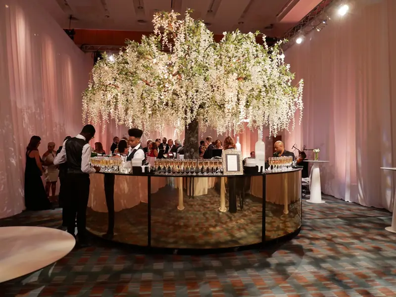 Mirrored gold wedding bar dressed with wisteria and flowers